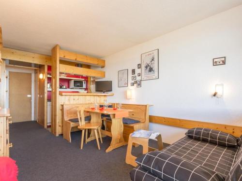 a bedroom with a bed and a table in a room at Appartement Les Arcs 1800, 2 pièces, 5 personnes - FR-1-346-427 in Arc 1800