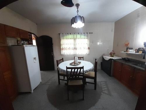 摩基達斯克魯易斯市的住宿－Sítio Nosso Cantinho，厨房配有桌椅和冰箱。
