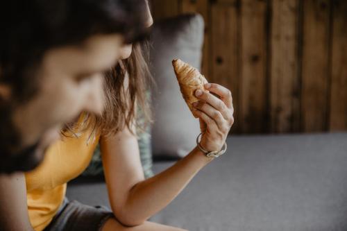 a woman holding a piece of bread in her hand at Feldgärtenhof in Silandro