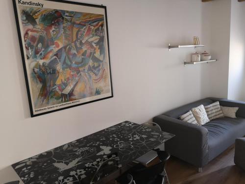 a living room with a couch and a painting on the wall at Appartamento in centro Bergamo in Bergamo