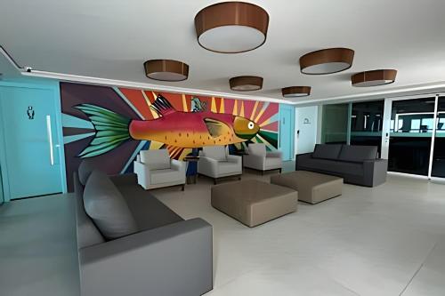 a room with a painting of a fish on the wall at Studios Premium RN in Maceió