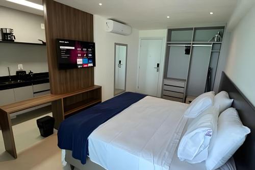 a bedroom with a bed and a television in it at Studios Premium RN in Maceió