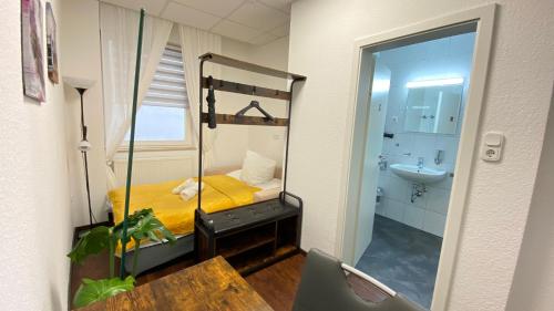 een slaapkamer met een stapelbed, een wastafel en een badkamer bij City Nowa 1 in Neurenberg