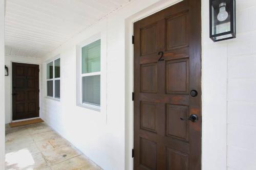 an empty hallway with a door and a window at Newly Renovated 1BR apartment in the heart of WPB in West Palm Beach