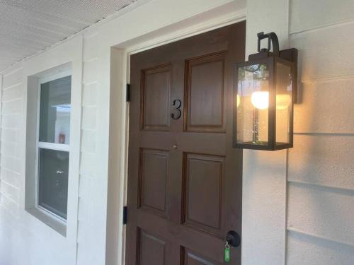 a door with a window and a light next to it at Lovely 1 Bedroom - Walk to Waterfront in West Palm Beach