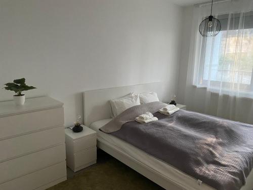 a bed with two towels on it in a bedroom at Edison Villa 204 in Fonyód