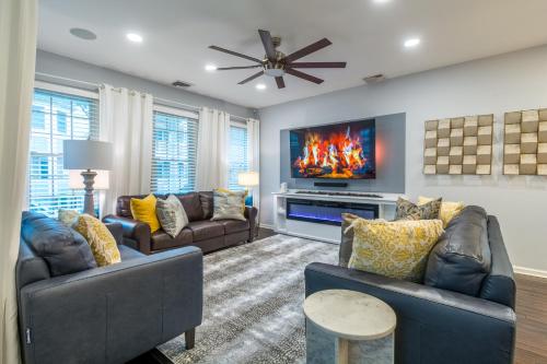 a living room with two couches and a tv at Luxury Beachside Vacation Getaway - OceanView, Movie Theatre, Mini Golf in Atlantic City