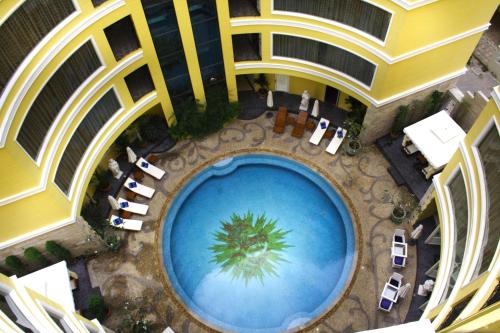 an overhead view of a swimming pool in a building at Four Seasons Place - SHA Extra Plus in Pattaya Central