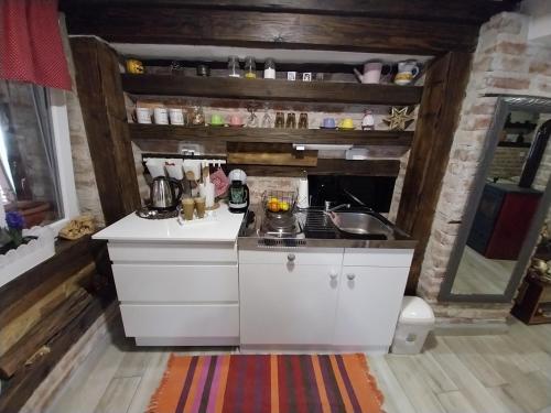 a kitchen with a sink and a counter top at Apartment Ada bed & breakfast in Gračac