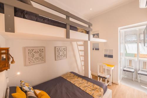 a bedroom with two bunk beds in a room at Encanto Townhouse Sliema in Sliema