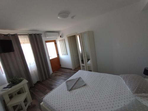 a bedroom with a bed with a paper on it at Pestele Ca Odinioară in Murighiol