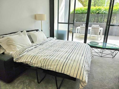 a bedroom with a bed and a glass table at Ground floor apartment in Lyons in Lyons