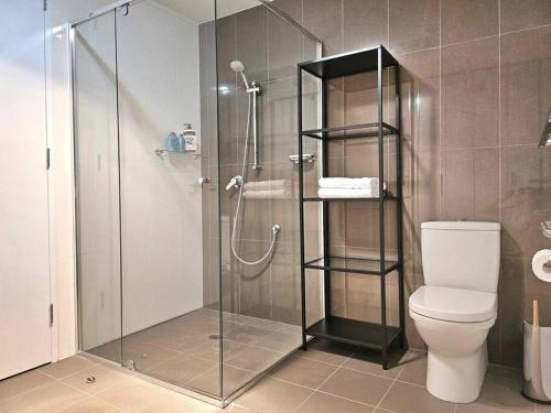 a bathroom with a glass shower with a toilet at Ground floor apartment in Lyons in Lyons