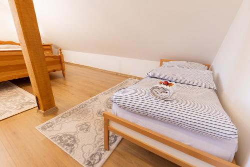 a small bed in a small room with a table at Bjelašnica Haven Lodge in Bjelašnica