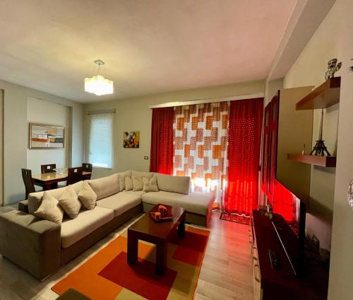 a living room with a couch and a table at Downtown Apartment in Korçë