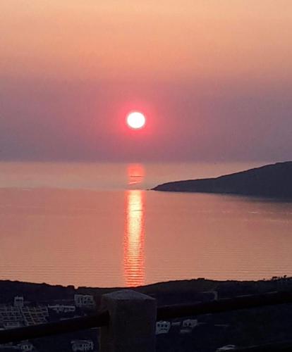 a sunset over a large body of water at PANORAMIO in Batsi