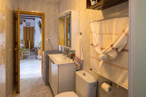 y baño con aseo y lavamanos. en Casa Asia en Granada