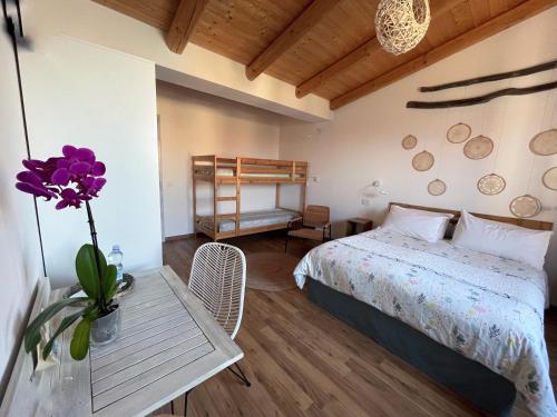 een slaapkamer met een bed en een tafel met een vaas met bloemen bij Torremana in Càbras