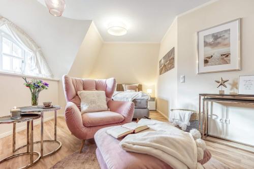 a living room with a couch and a chair at Ferienhaus Haubenlerche 27 in Fuhlendorf