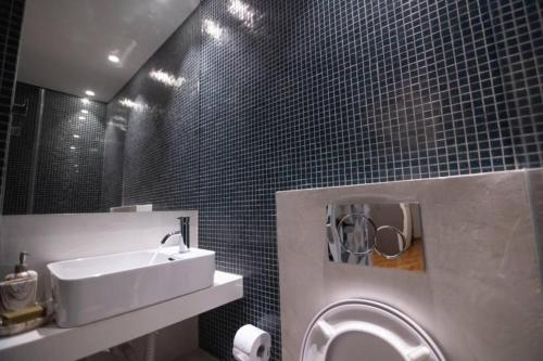 a bathroom with a sink and a mirror at Xenia's Cozy Apartment (near Acropolis Museum) in Athens