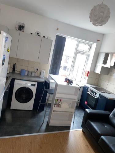 a small kitchen with a washing machine in it at Westend Villas in Leicester