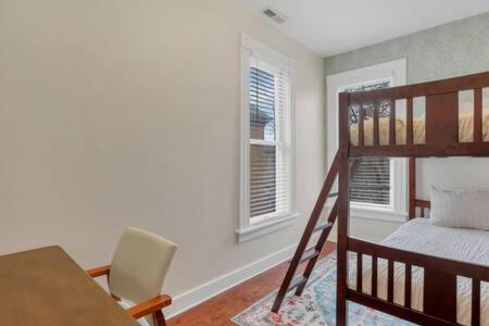 a bedroom with a bunk bed and a table and a chair at Historic Elegance Retreat - Columbus Downtown in Columbus