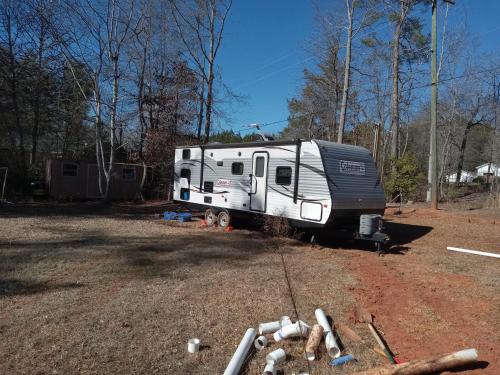 an rv parked in a field in the woods at Beautiful Camper on quiet lot in the foothills of Western NC in Rutherfordton