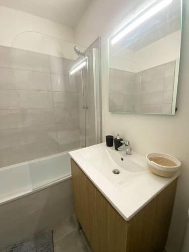 une salle de bain blanche avec un lavabo et une douche dans l'établissement Charmant T2 Rénové+Parking privé, à Aucamville