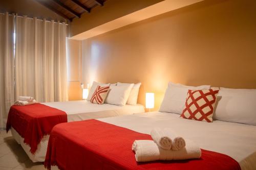 a bedroom with two beds with towels on them at Porteño Loft Búzios in Búzios