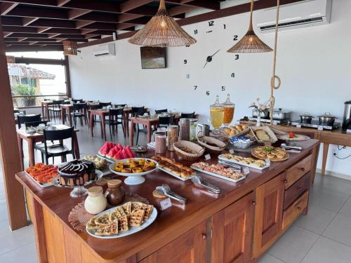 a buffet line with many different types of food at Terra Bella Pousada in Morro de São Paulo