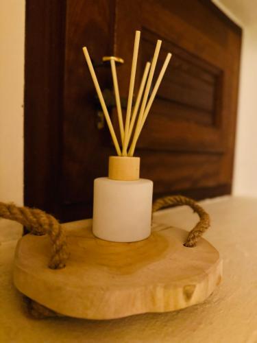 a candle holder on a table with some sticks in it at B&B La Vista Brava in Platja  d'Aro