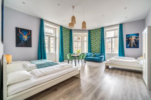 a bedroom with two beds and a dining room at Downtown Delight - Erzsébet BLVD - 13 PPL in Budapest