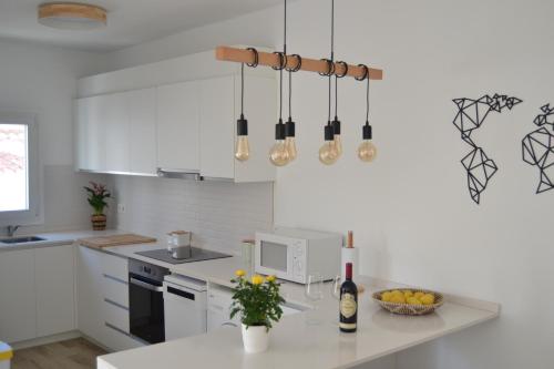 a kitchen with white cabinets and a white counter top at Apartamento en Binibeca Nou in Binibeca