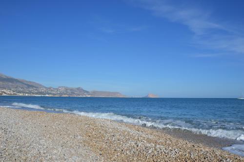 a rocky beach with the ocean in the background at Albir Beach Apt in Albir