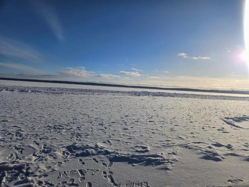 a beach with the words happy new year written in the sand at *4BR 2BA N Shore Hidden Retreat* in Roscommon