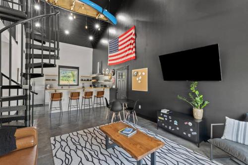 a living room with a couch and a tv on a wall at New Barndo/Kayak Launch/ 2 Private Hot Tubs in Stanton