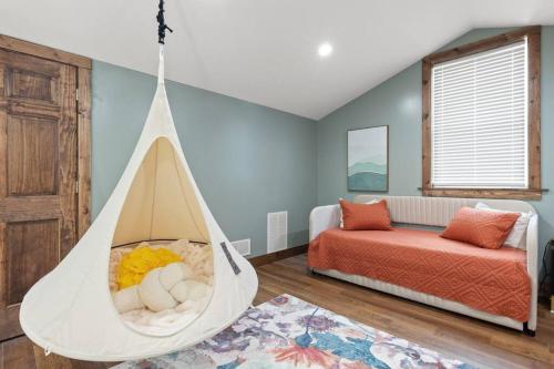 a swing in a room with a bed and a bedroom at New Barndo/Kayak Launch/ 2 Private Hot Tubs in Stanton