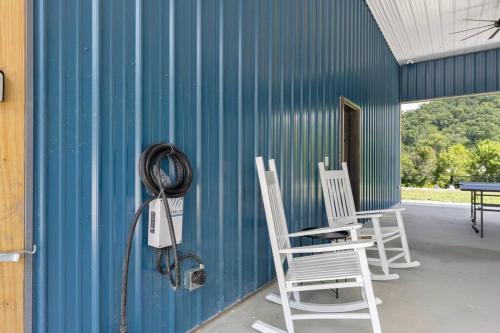 a group of chairs sitting on the side of a building at New Barndo/Kayak Launch/ 2 Private Hot Tubs in Stanton