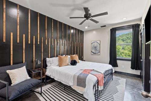 a bedroom with a bed and a ceiling fan at New Barndo/Kayak Launch/ 2 Private Hot Tubs in Stanton