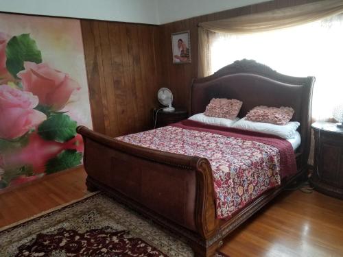 a bedroom with a bed in a room with a window at Fully renovated 4 bd with 2 master suits, 3 bth home in centralized location in Keaau