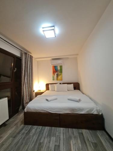 a bedroom with a large bed with two pillows at Guesthouse Hotel My Home in Prizren