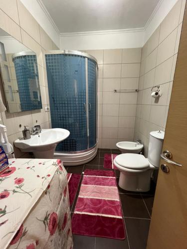 a bathroom with a sink and a toilet at Elbasan center family apartment n.42 in Elbasan