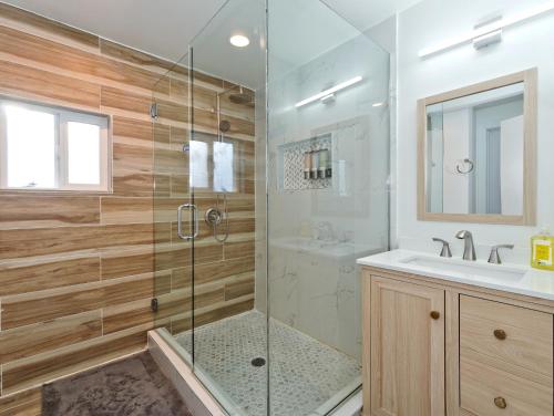 a bathroom with a glass shower and a sink at Mid-Century Seattle Home w/ Lakefront Views! in Seattle