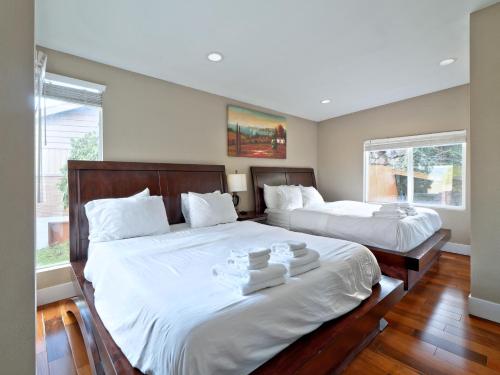 a bedroom with two beds with white pillows at Mid-Century Seattle Home w/ Lakefront Views! in Seattle