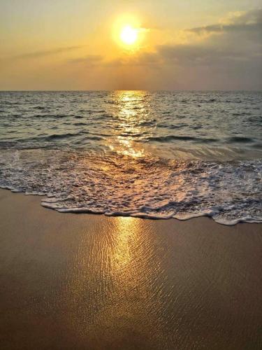 a sunset on a beach with the ocean at Serendip Villa Holiday HomeTalalla Sri Lanka in Matara