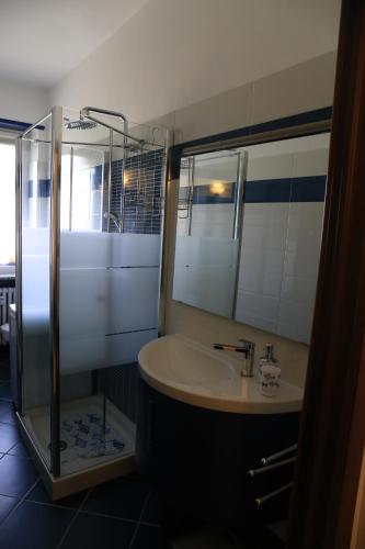 a bathroom with a sink and a shower at Faber House in Venaria Reale