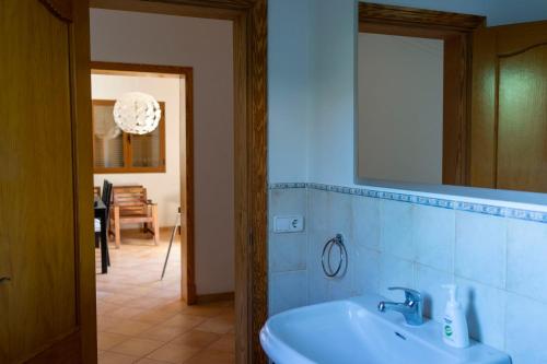 a bathroom with a sink and a mirror at Chalet Font de Sa Cala in Font de Sa Cala