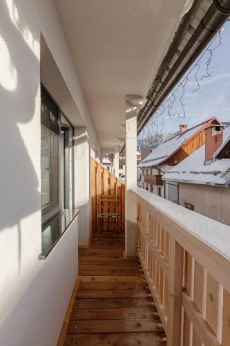 a balcony of a house with a wooden floor at Deluxe Apartments 55 in Kranjska Gora