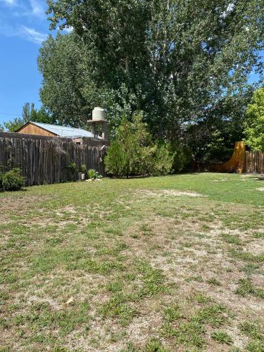 a yard with a wooden fence and a water tower at Posada Uspallata in Uspallata