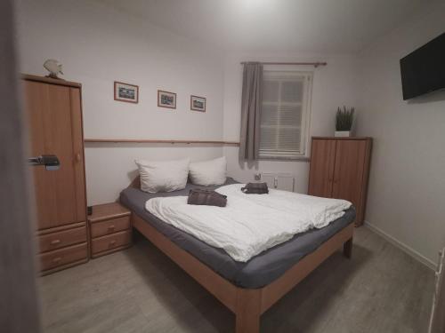 a bedroom with a bed with two bags on it at Apartmenthaus Atlantik in Kühlungsborn